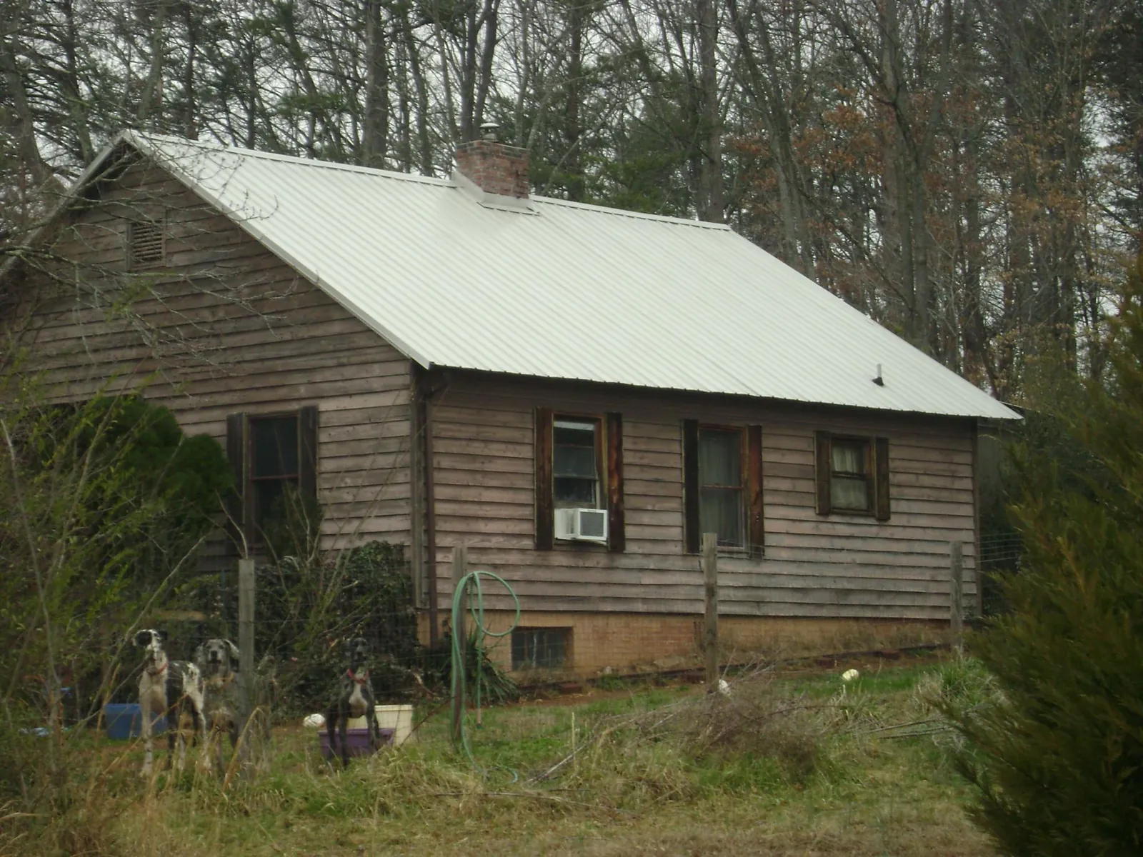 White metal roof on an old wood sided farmhouse, from a Metal Roof Installation job in Sandusky